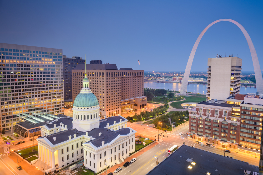 St. Louis, Missouri, USA downtown cityscape with the arch and courthouse at dusk.